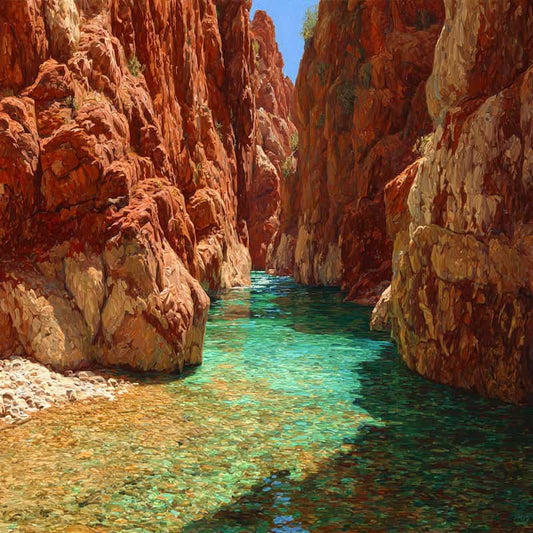 Tight shot of a narrow canyon with clear blue water and red rock walls.