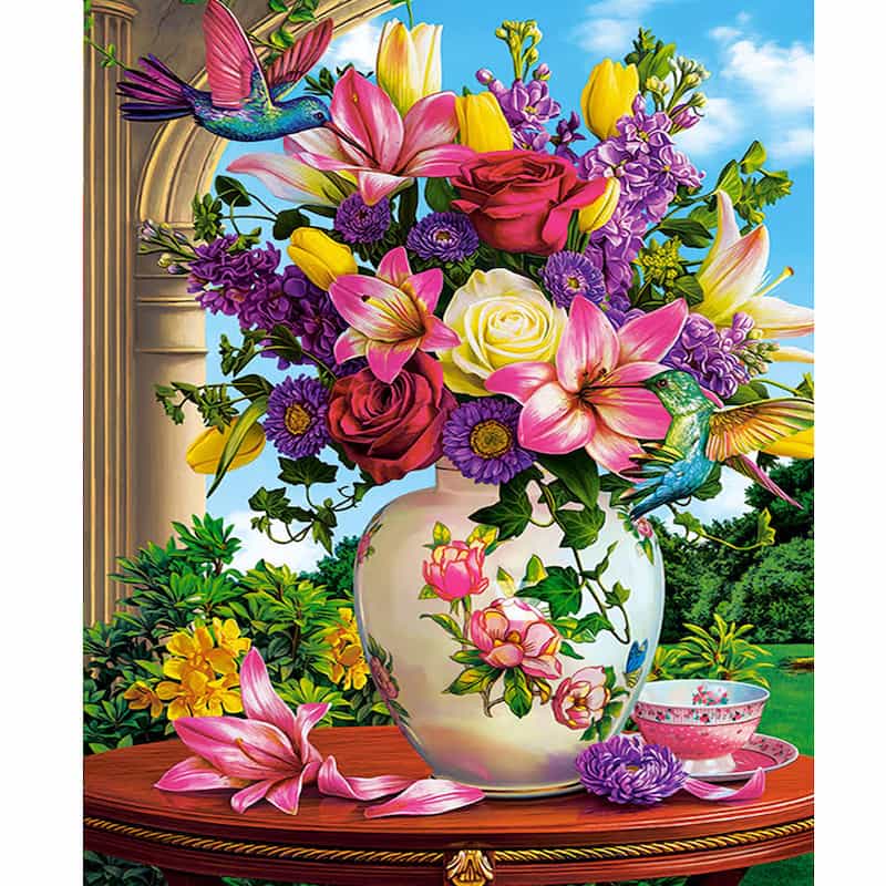 Colorful flowers in a vase with hummingbirds against a scenic background