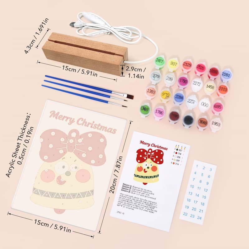 Christmas acrylic painting kit with a wooden block, paintbrushes, multiple small paint pots, a printed Christmas ornament design, instruction sheet, and numbered grid on a light beige background.