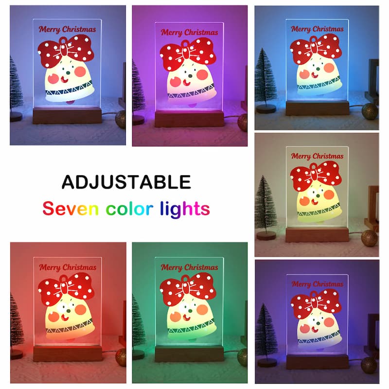 A collage showing a Christmas-themed adjustable LED table lamp in seven different color modes, with a central text overlay reading 'ADJUSTABLE Seven color lights'. The lamp features a cartoon snowman wearing a red polka-dot bow and the text 'Merry Christmas' on a clear acrylic panel, set on a wooden base.