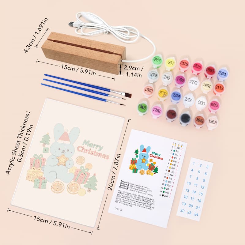 DIY Christmas canvas painting kit with a wooden frame, acrylic paint pots, two paintbrushes, an acrylic sheet with a bunny illustration, a color chart, and a number grid, shown with dimension labels on a light beige background.