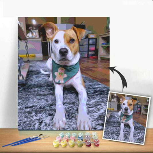 Dog wearing a bandana with a painting setup on a table