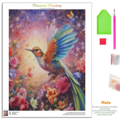 Diamond painting kit featuring a colorful hummingbird and floral design on a canvas, shown alongside included tools: a green palette, pink pencil, red color chip, and bead packets. Text at the top reads 'Diamond Painting' and a note explains bead quantity and pattern reference.