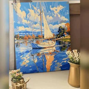 Painting of a sailboat on water with a blue sky and clouds, displayed indoors.