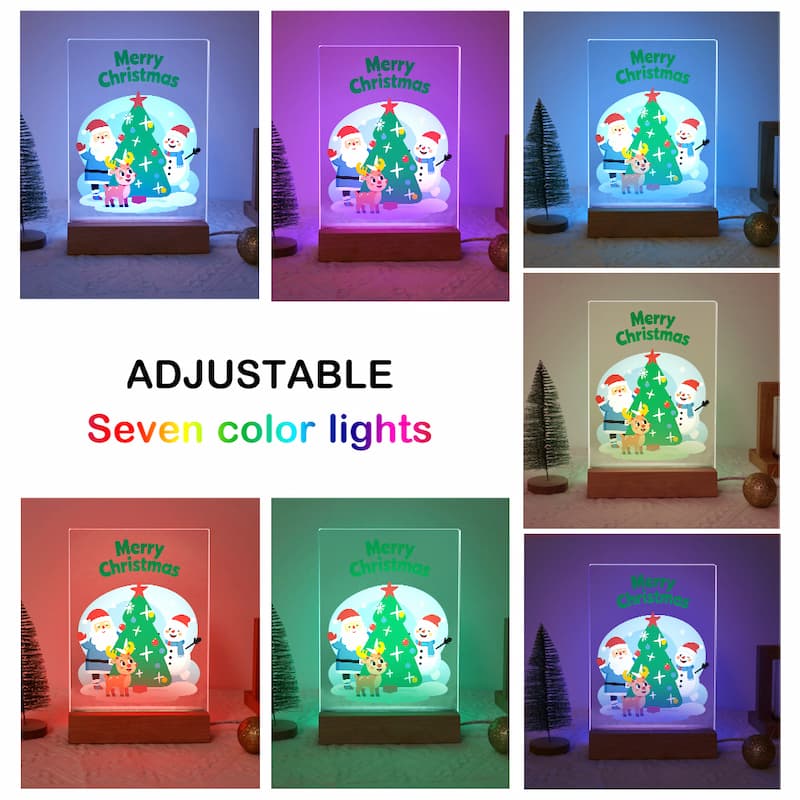 A collage showing a tabletop Christmas night light in seven different adjustable colors, with the text 'ADJUSTABLE Seven color lights' in the center. The product has a clear acrylic dome with a printed Christmas scene of Santa Claus, a snowman, and a Christmas tree, sitting on a wooden base.