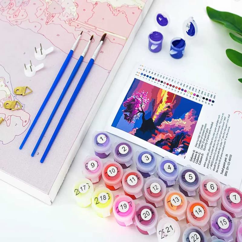 Set of colorful printing stamps with numbers and letters, brushes, and a color chart on a table.