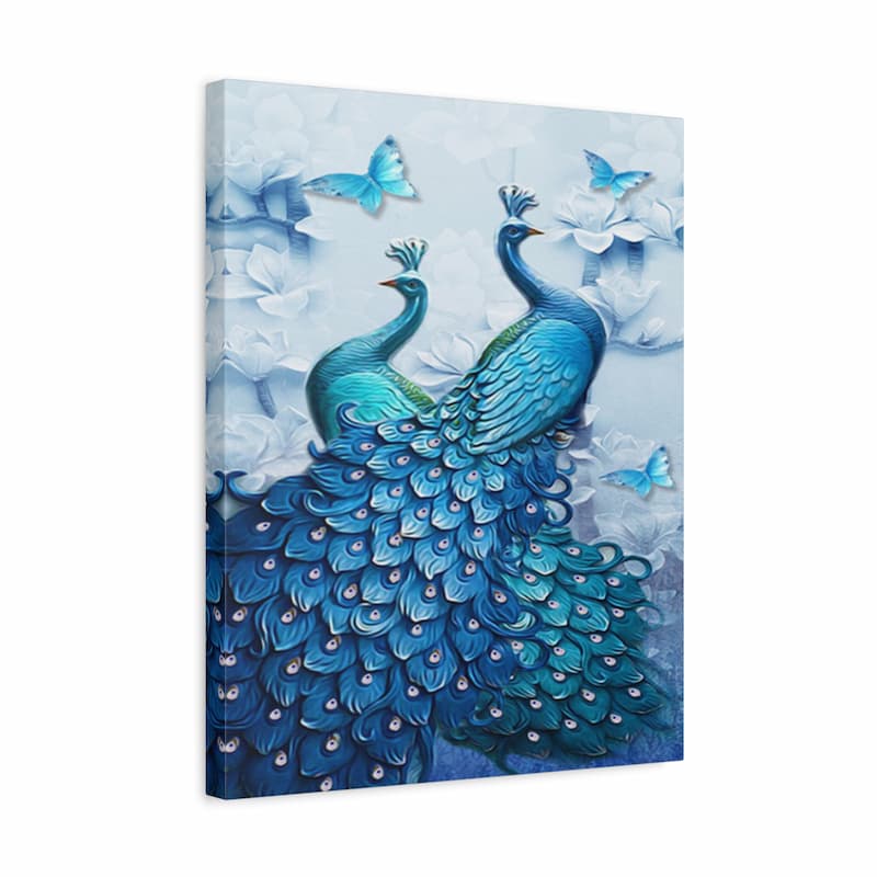 A square canvas wall art print featuring two blue peacocks with elaborate feathered tails, surrounded by white flowers and light blue butterflies on a pale blue background.