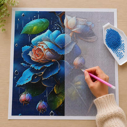 Person working on a diamond painting project with blue flowers and leaves.