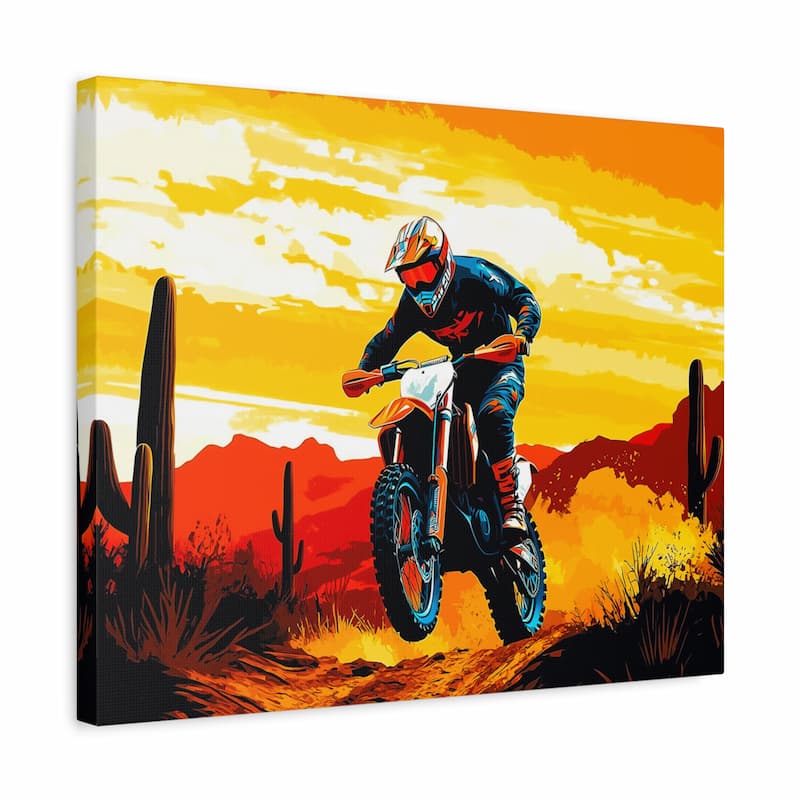 Canvas print of a motocross rider in a desert landscape with cacti and a sunset sky.