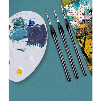 Three micro detail brushes for paint by numbers laid next to a used paint palette and a finished floral canvas