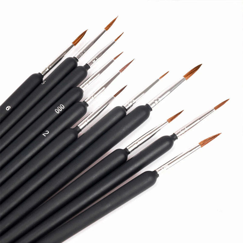 Set of black paintbrushes with varying sizes on a white background